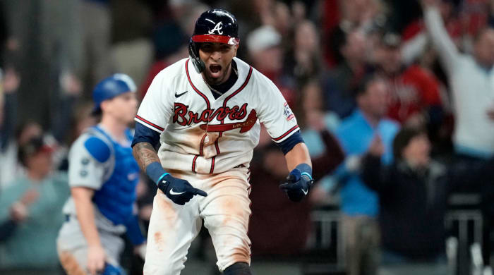 Oct 17, 2021; Cumberland, Georgia, USA; Atlanta Braves left fielder Eddie Rosario (8) celebrates his walk off game winning RBI against the Los Angeles Dodgers during the ninth inning in game two of the 2021 NLCS at Truist Park.